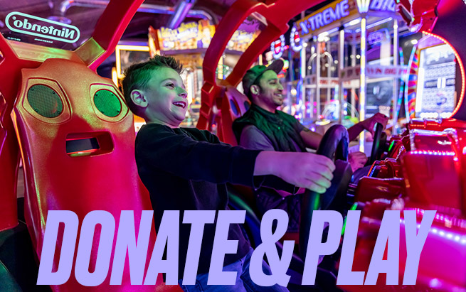 Adult and child play games in the Arcade at Arena Sports Mill Creek