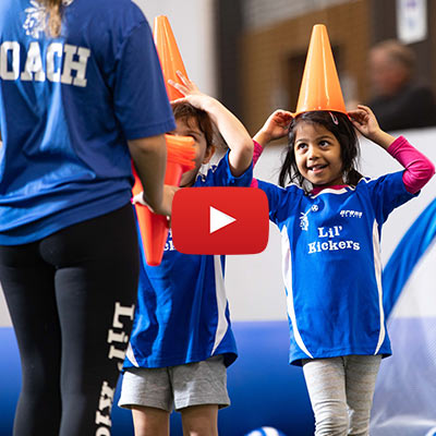 Kids have fun with soccer cones during a Lil' Kickers soccer class at Arena Sports