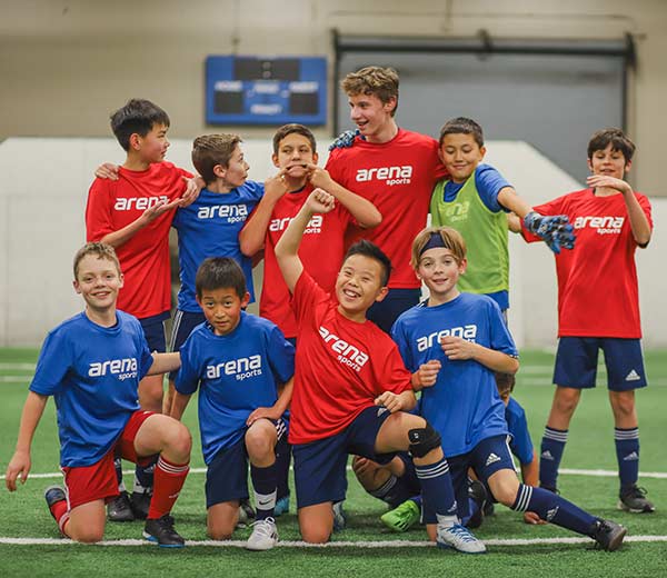 Youth league boys team in silly poses for photo at Arena Sports