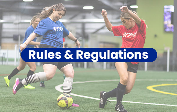 Two women play soccer during Indoor Adult League game at Arena Sports