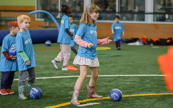 Kids play field games at Arena Sports Summer Camp