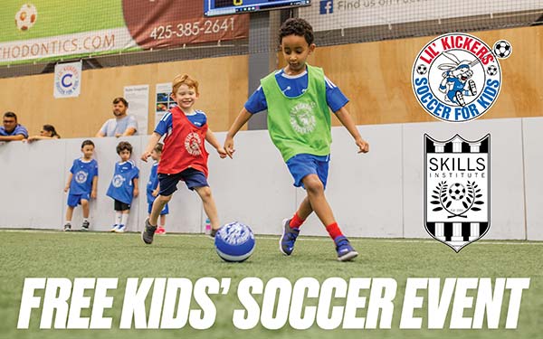 Two boys play soccer in a soccer class at Arena Sports